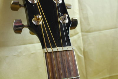 Cropped image of guitar on fabric