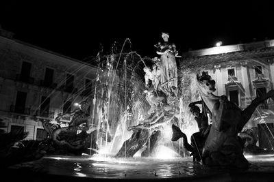 Illuminated fountain at night