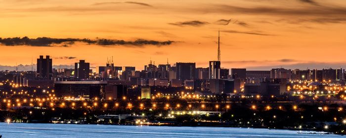 Illuminated city at sunset