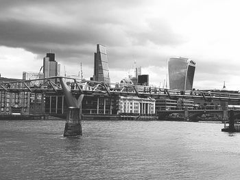 View of bridge over river against cloudy sky