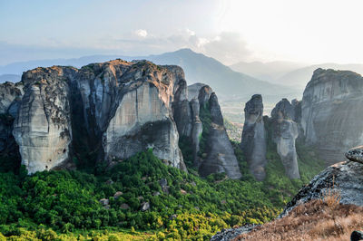 Rock formations against cloudy sky