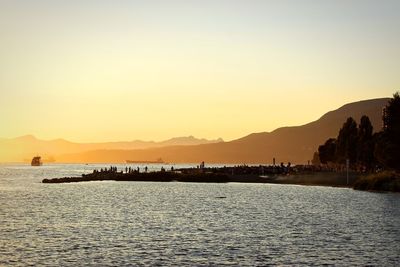 Scenic view of sea against clear sky during sunset