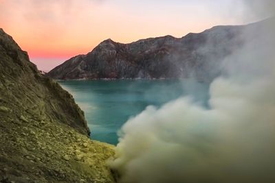 Scenic view of lake against sky during sunset