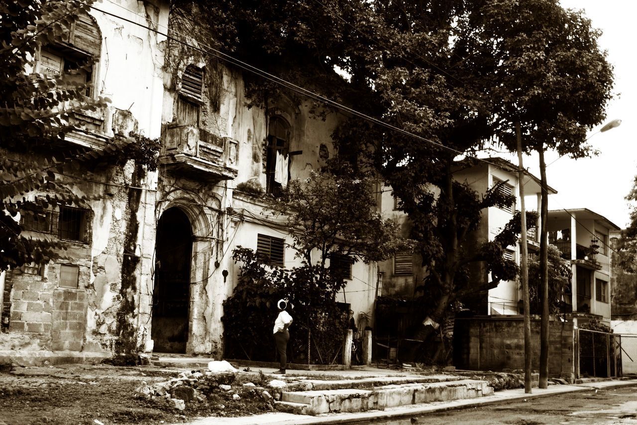 MAN IN FRONT OF BUILDINGS