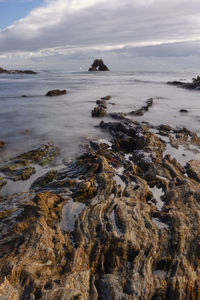 Rock lines leading to an ocean arch