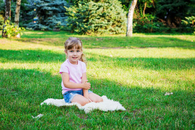 Full length of a girl sitting on field