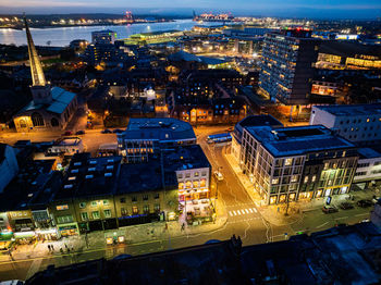 High angle view of illuminated buildings in city