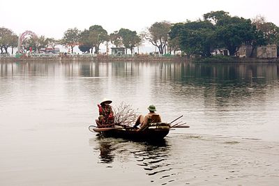 People sitting on boat in river