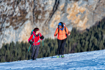 People walking on snow covered mountain