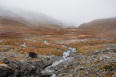 Scenic view of mountains against sky with running water,  jostedalsbreen norway