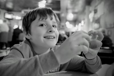 Smiling cute boy sitting at restaurant