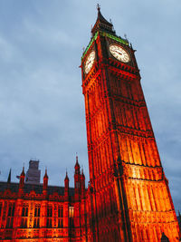 Low angle view of illuminated building against sky