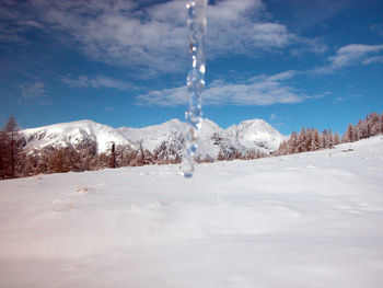 Snow covered field against sky