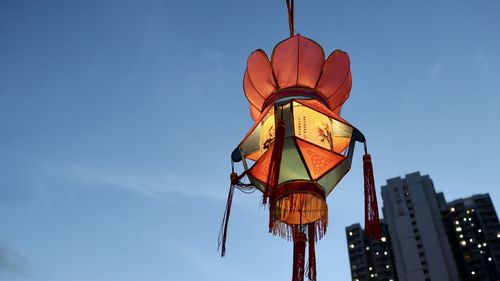 Low angle view of illuminated street light against sky