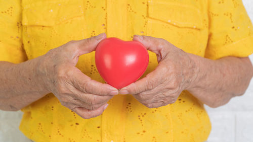 Close-up of hand holding red