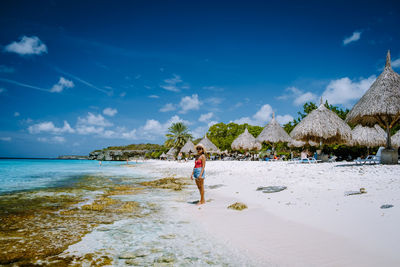 Woman on beach against sky