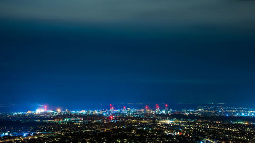 Cardiff illuminated cityscape against sky at night. 