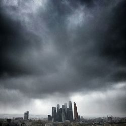 City skyline against cloudy sky