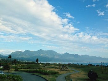 Scenic view of mountains against cloudy sky