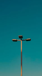 Low angle view of street light against clear blue sky