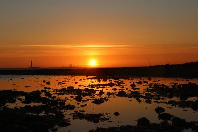 Scenic view of sea against romantic sky at sunset