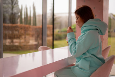 Side view of eating ice cream at parlour