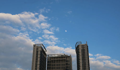 Low angle view of buildings against blue sky