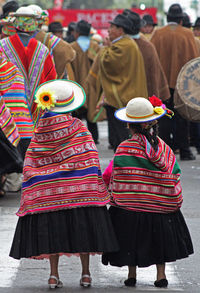 Rear view of people walking in city