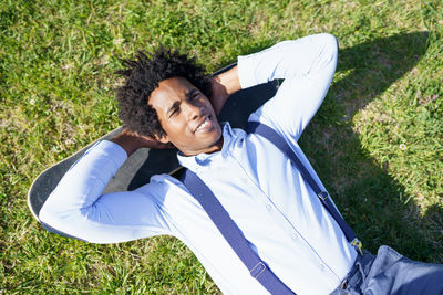 High angle view of man lying on grass