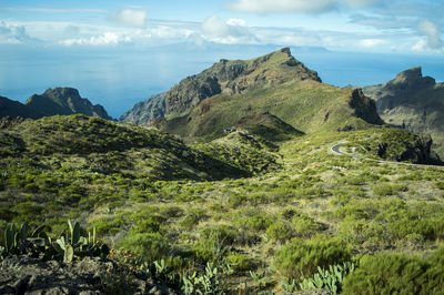 Scenic view of sea and mountains against sky