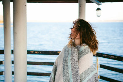 Close-up of woman standing on pier over sea