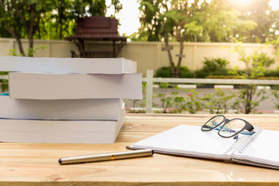 Close-up of books and eyeglasses on table