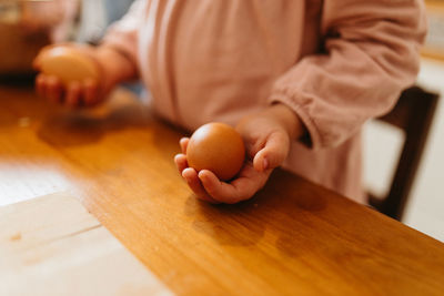 Mid section child holding eggs