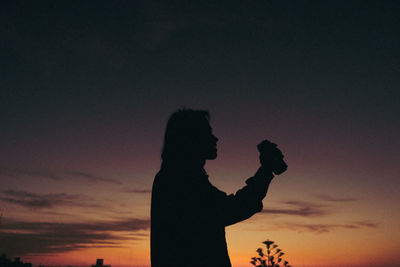 Man drinking a beer durning sunset