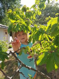 Portrait of smiling girl against plants