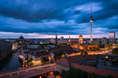 High angle view of city lit up at night