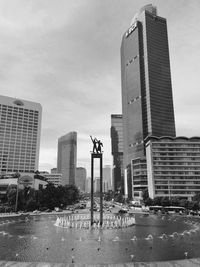 Buildings in city against sky