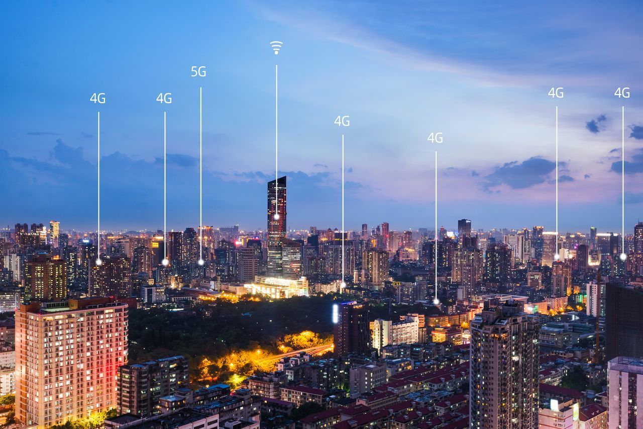 ILLUMINATED BUILDINGS AGAINST SKY AT NIGHT