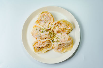 High angle view of food in plate on white background