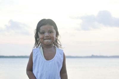 Portrait of smiling girl standing at beach