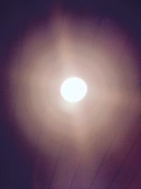 Low angle view of illuminated moon against sky