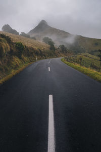 Empty road into the mountains of banks peninsula, new zealand