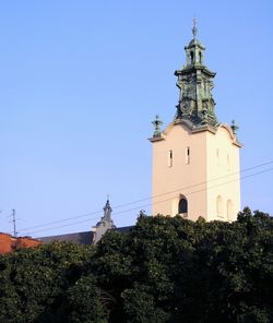 High section of built structure against clear blue sky