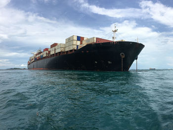 Ship sailing on sea against sky