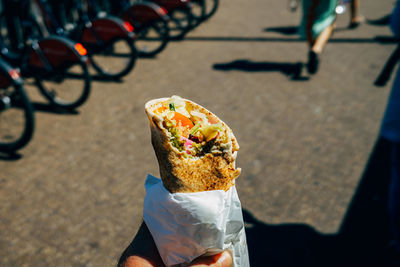 Hand holding streetfood wrap