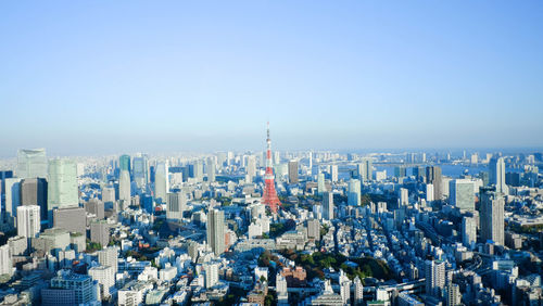 Panoramic view of city buildings against blue sky