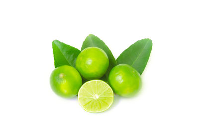 Close-up of green tomatoes against white background