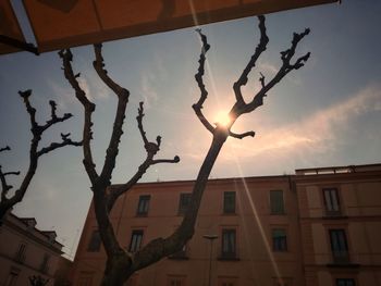 Low angle view of silhouette buildings against sky