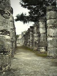 Cobblestone street amidst stone wall