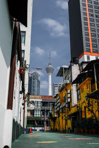 Buildings in city against cloudy sky